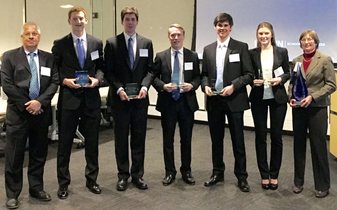 CFA Research Challenge winning team with mentors. Pictured L to R: faculty mentor Chris Wilkos, finance students Tom MacLean, Tommy Stodolski, Sean Phelan, Louis Beck, and Anna Pojawis, and industry mentor Leslie White. (Lisa Piker/Cigna)