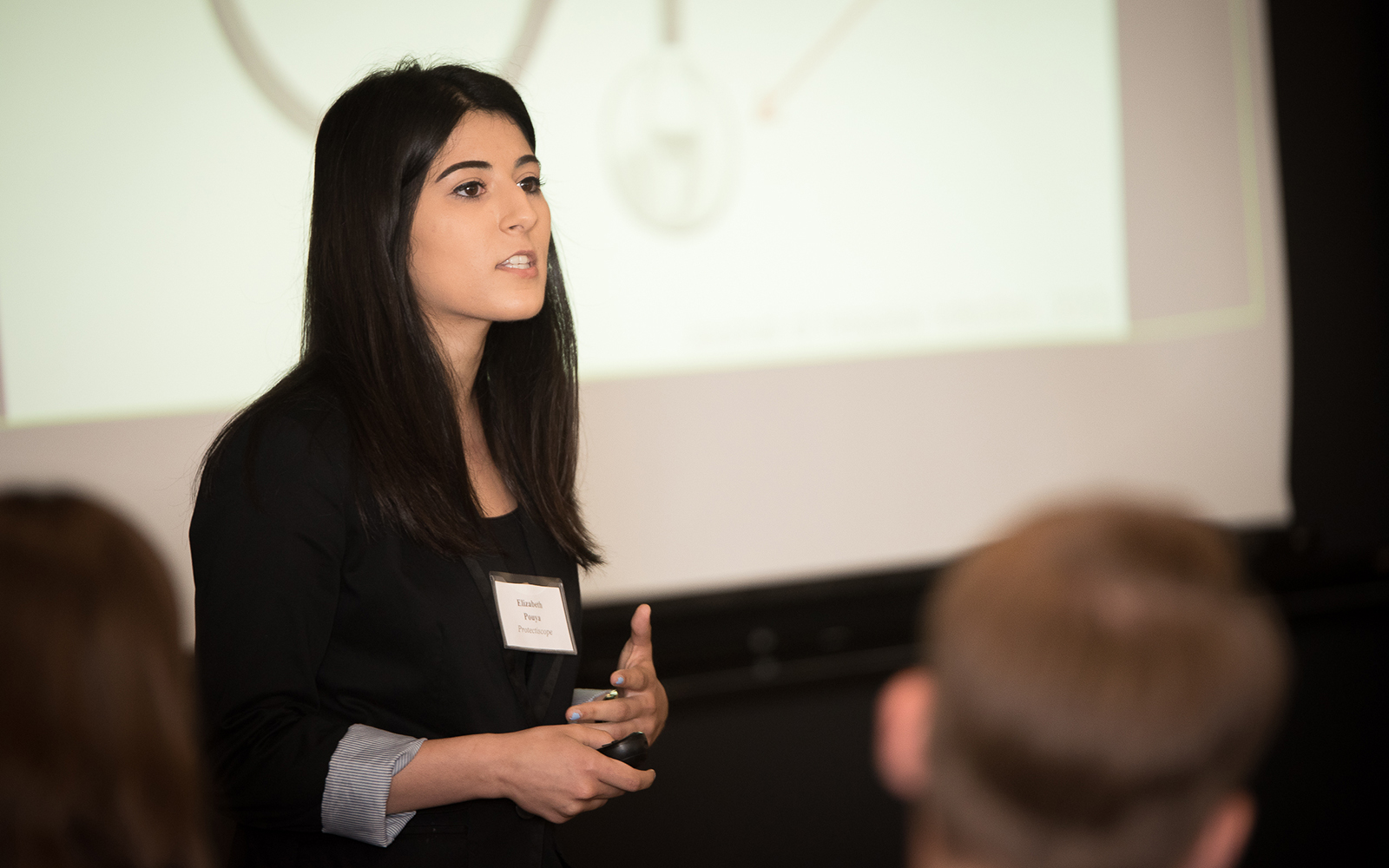 Elizabeth “Liz’’ Pouya, a rising senior majoring in physiology and neurobiology, who ultimately hopes to become a physician, presents her idea to prospective investors. (Nathan Oldham/UConn School of Business)