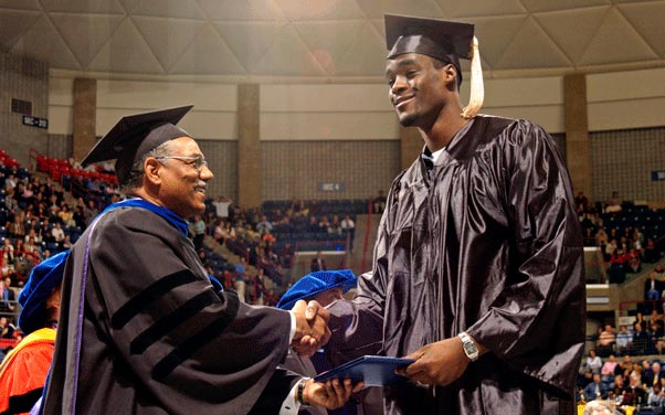 Emeka Okafor receives his diploma from former School of Business Dean Curt Hunter during Commencement ceremonies at Gampel Pavilion in May 2004. (Ryan McKee/NCAA Photos)