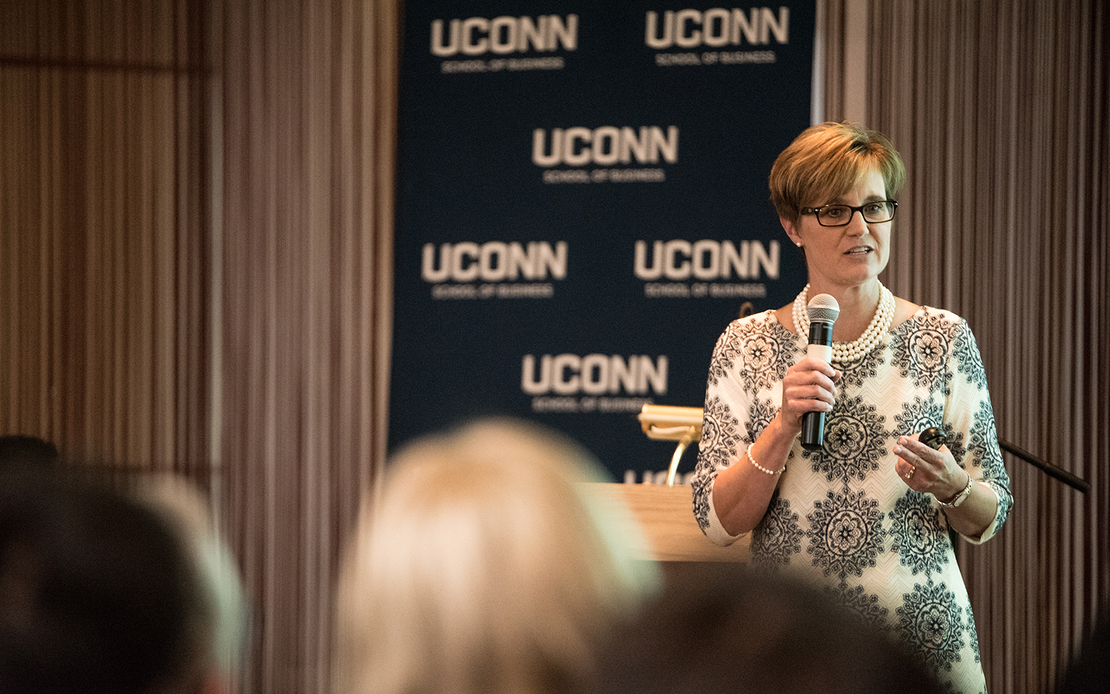 Corliss Montesi '86, vice president and corporate controller at Stanley Black & Decker, addresses hundreds of enthusiastic students at one of several graduate student Convocation events. (Nathan Oldham/UConn School of Business)