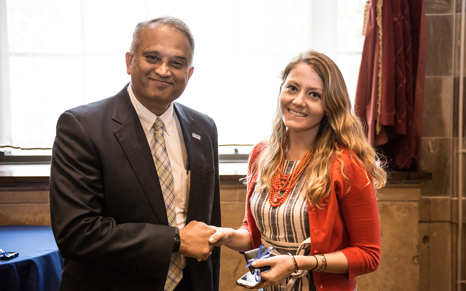 Associate Dean Suresh Nair shakes hands with Jenny Kowalski '17 MBA at the annual MBA Awards Ceremony earlier this month. (Nathan Oldham/UConn School of Business)