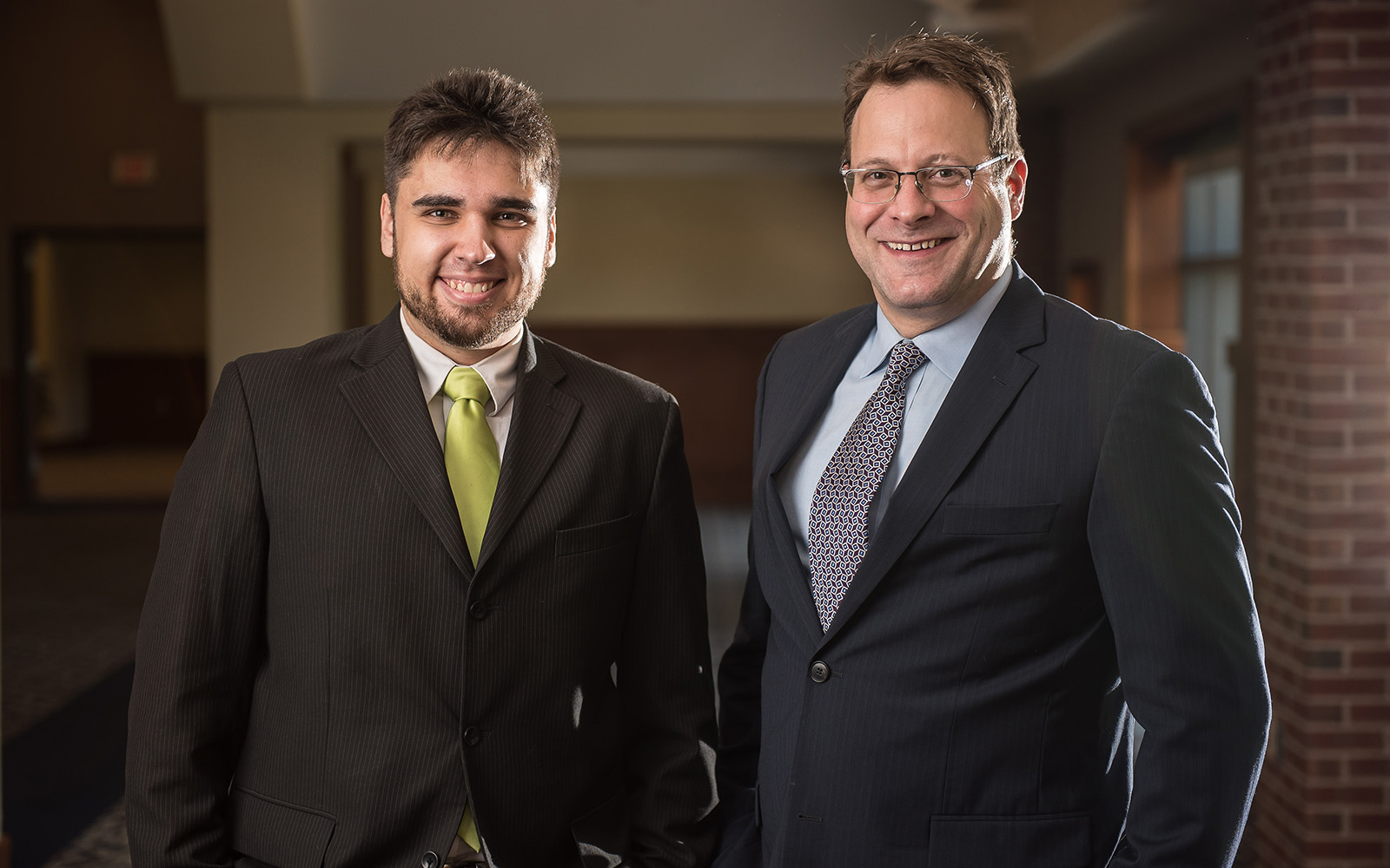 Kostyantyn Partola, an engineering Ph.D. candidate, poses for a photo with adviser Thomas Geer prior to the start of the Wolff competition. Missing from photo is Professsor George Lykotrafitis from the School of Engineering. (Nathan Oldham/UConn School of Business)