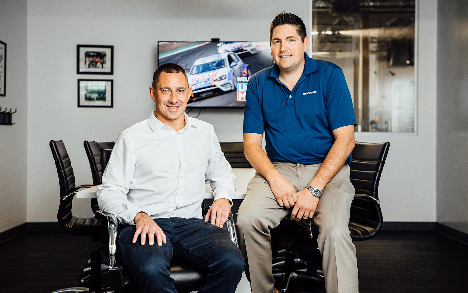 Alumnus Scott Drozd and business partner Nick Bauer pose for a photo at the headquarters of their highly successful FCP Euro auto parts company in Milford. (Nathan Oldham/UConn School of Business)