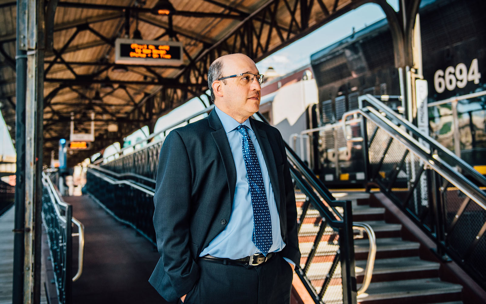 Professor Jeff Cohen , pictured above, at Union Station in Hartford, is studying the impact that a new passenger rail line will have on residential and commercial development. The train, which travels from New Haven to Springfield, Mass., with many stops in between, began service in June. (Nathan Oldham/UConn School of Business)