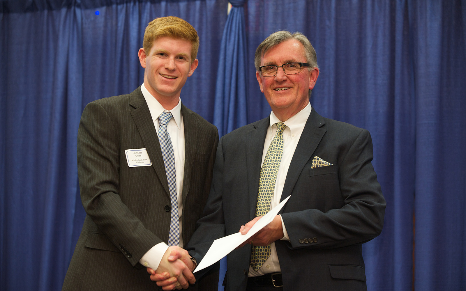 In this 2014 file photo, Professor Larry Gramling, then associate dean of Undergraduate Programs, poses with scholarship recipient Joseph Quinn during the Accounting Honors Banquet. (Kim Bova/UConn School of Business)