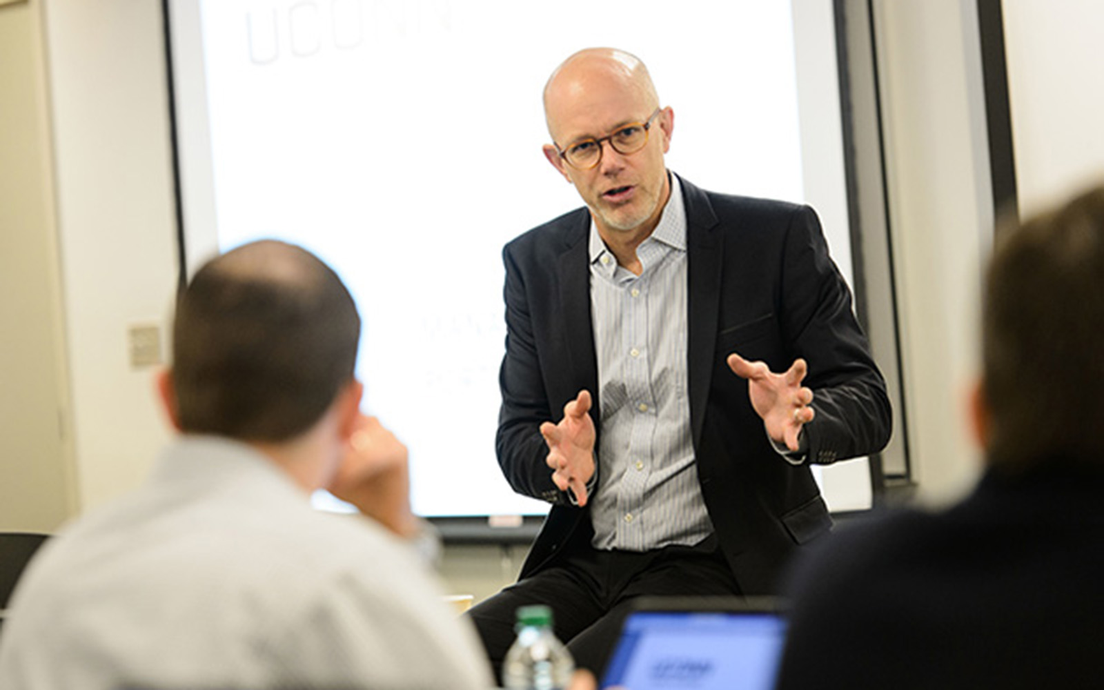 Timothy Folta, professor of management, leads a class at the Graduate Business Learning Center in Hartford. Folta is director of the Connecticut Center for Entrepreneurship and Innovation at UConn. (Peter Morenus/UConn File Photo)