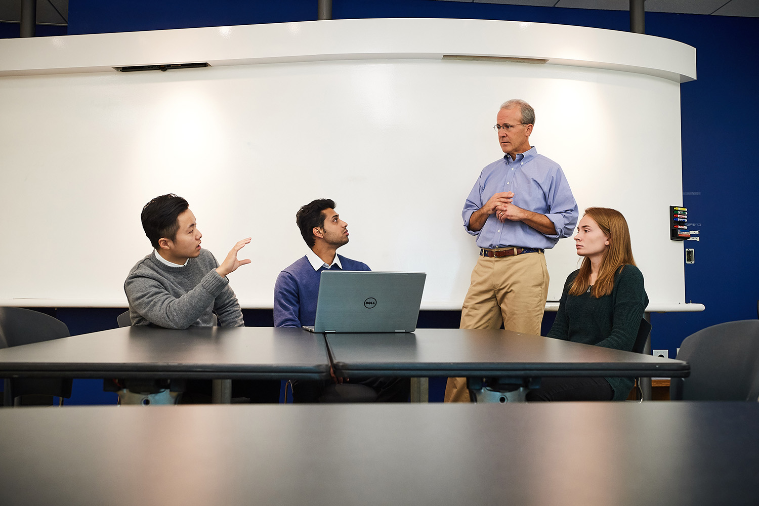 Former Goldman Sachs partner Blake Mather, advisor to a new Student Managed Fund at UConn Stamford, meets with student managed fund members Di Yang, left, Anshul Manglani, both graduate students, and Lindsey Lozyniak '19 (BUS). (Peter Morenus/UConn Photo)