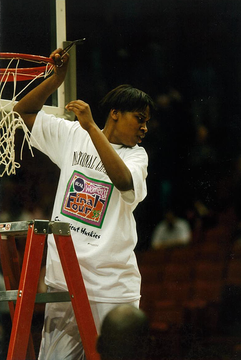Jamelle Elliott, cutting down the net after the Huskies victory at the 1995 NCAA Championship. (Contributed Photo)