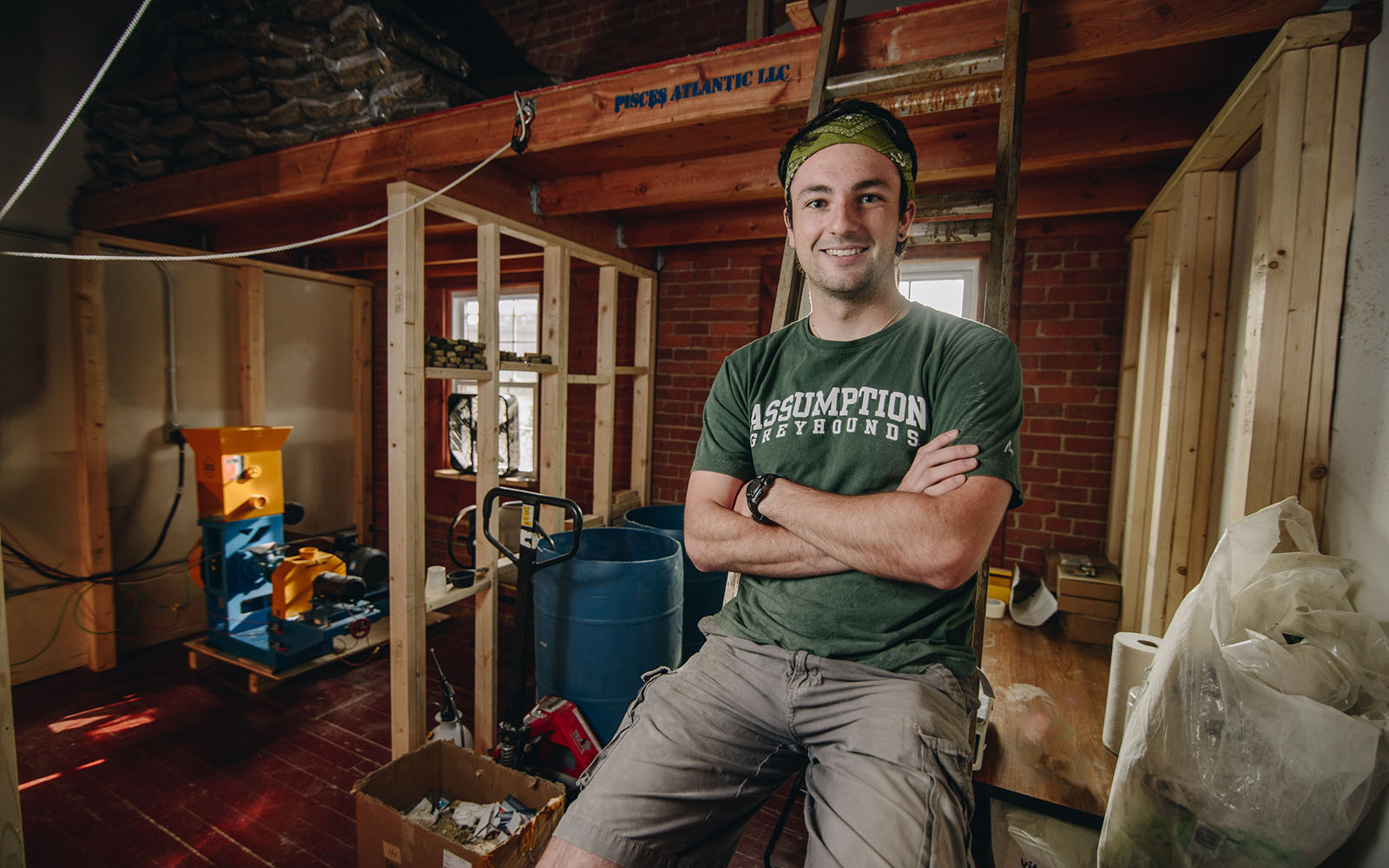 UConn Student Peter Goggins poses in a rustic warehouse.