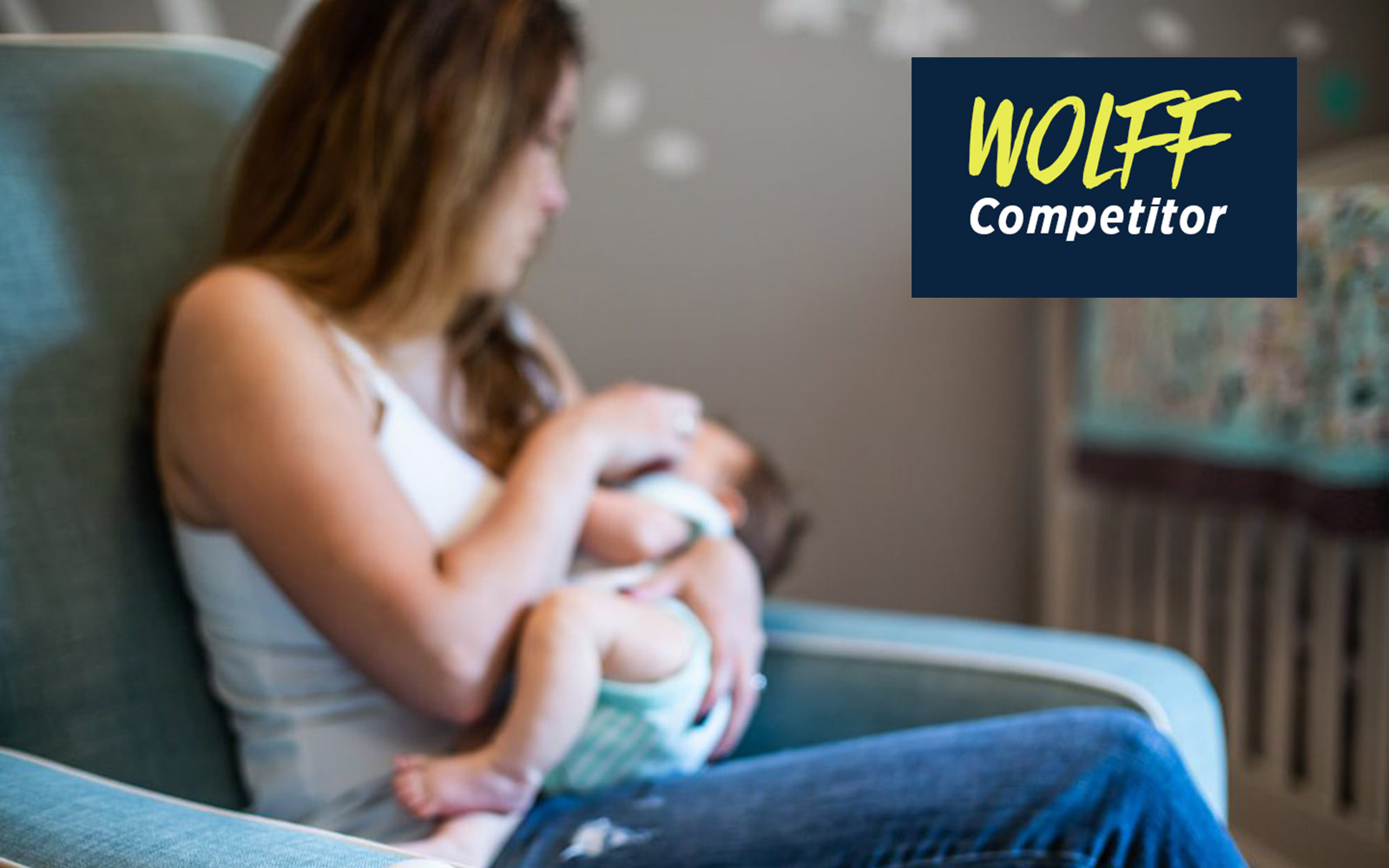 Woman holding her baby with a blurred effect and the test "WOLFF Competitor."