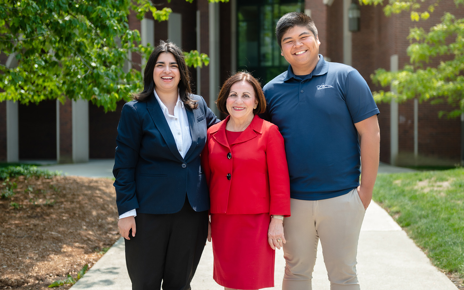 Students Aria Penna (left) and Luis Quisumbing (right) pose for a photo with donor Toni Boucher ’02 MBA (Nathan Oldham / UConn School of Business