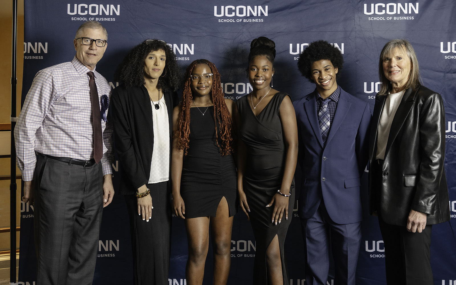 Alumnus Rich Eldh ’81 and his wife Joyce Eldh are supporting 13 Bridgeport students who are pursuing their degrees from UConn through the Eldh Family Scholarship Fund. The couple recently attended the School of Business’ Hall of Fame ceremony with some of their scholars. Pictured from left are: Rich Eldh, alumna Jayde Lopez ’24, undergraduates Francesca Rameau, Stenielza Marseille and Elyjeh Ortiz and Joyce Eldh.