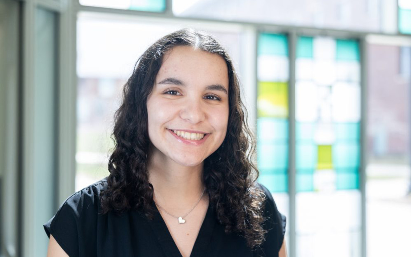 Julianna Cushner '25 (BUS) poses for a photo in the Business Building in Storrs on Wednesday, March 26, 2025. (Sydney Herdle/UConn Photo)