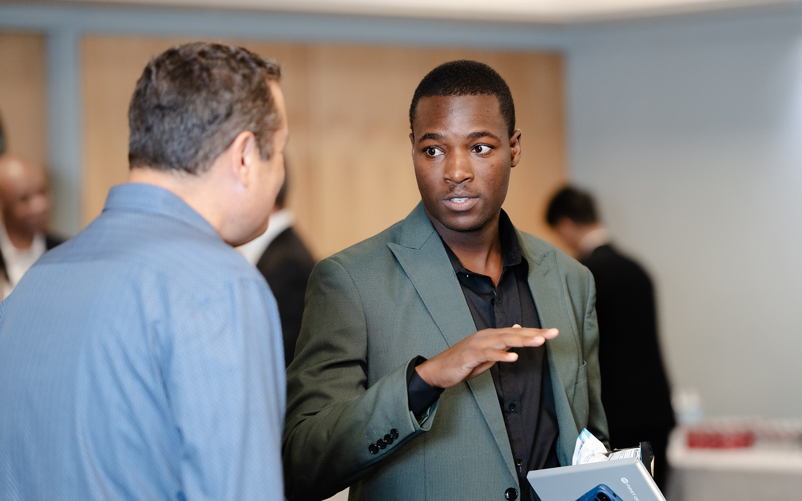FERM graduate student Malcolm Dhikinya speaks with an Executive at UConn's Risk Manager on Campus event.