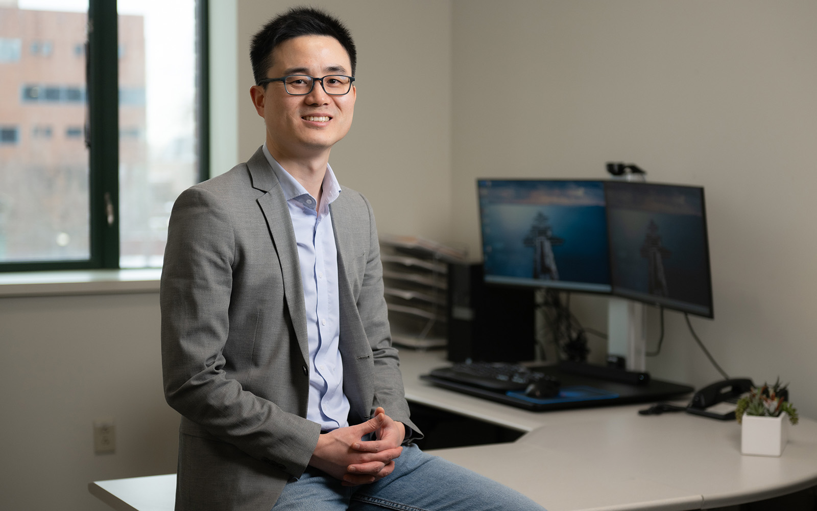 OPIM Professor Jing Peng, in his office in Storrs, CT (Nathan Oldham / UConn School of Business)