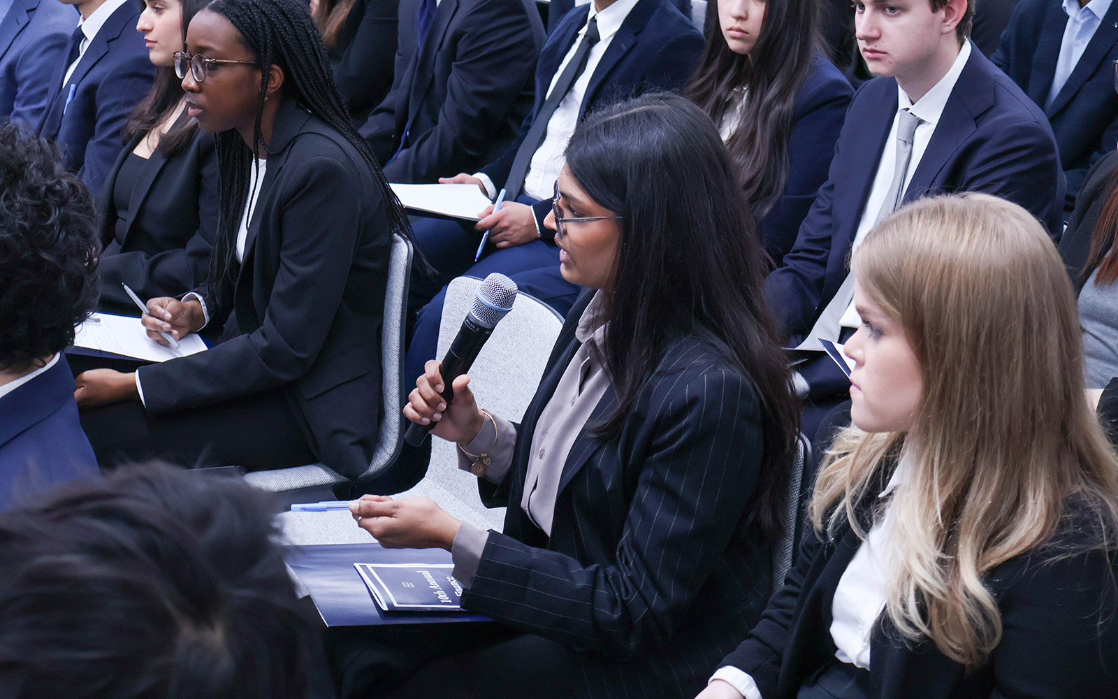 Finance student Vibeke Iyer '27 asks a question during the Finance Society's trip to Wall Street last week.