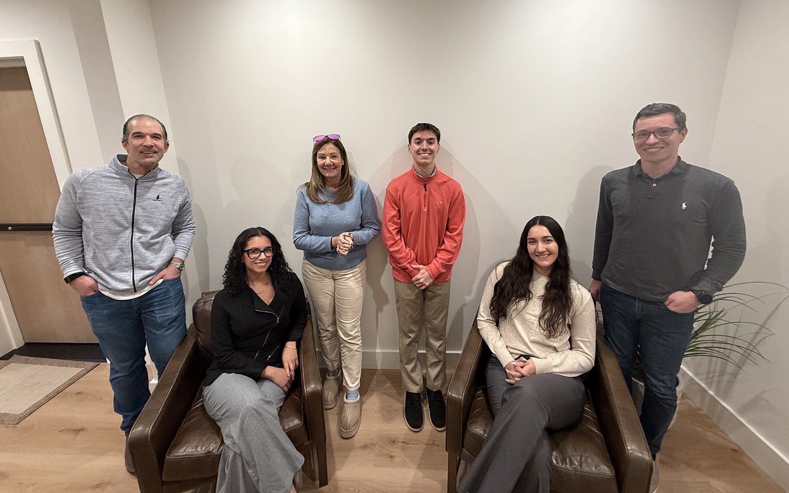 A group of people posing in an office environment