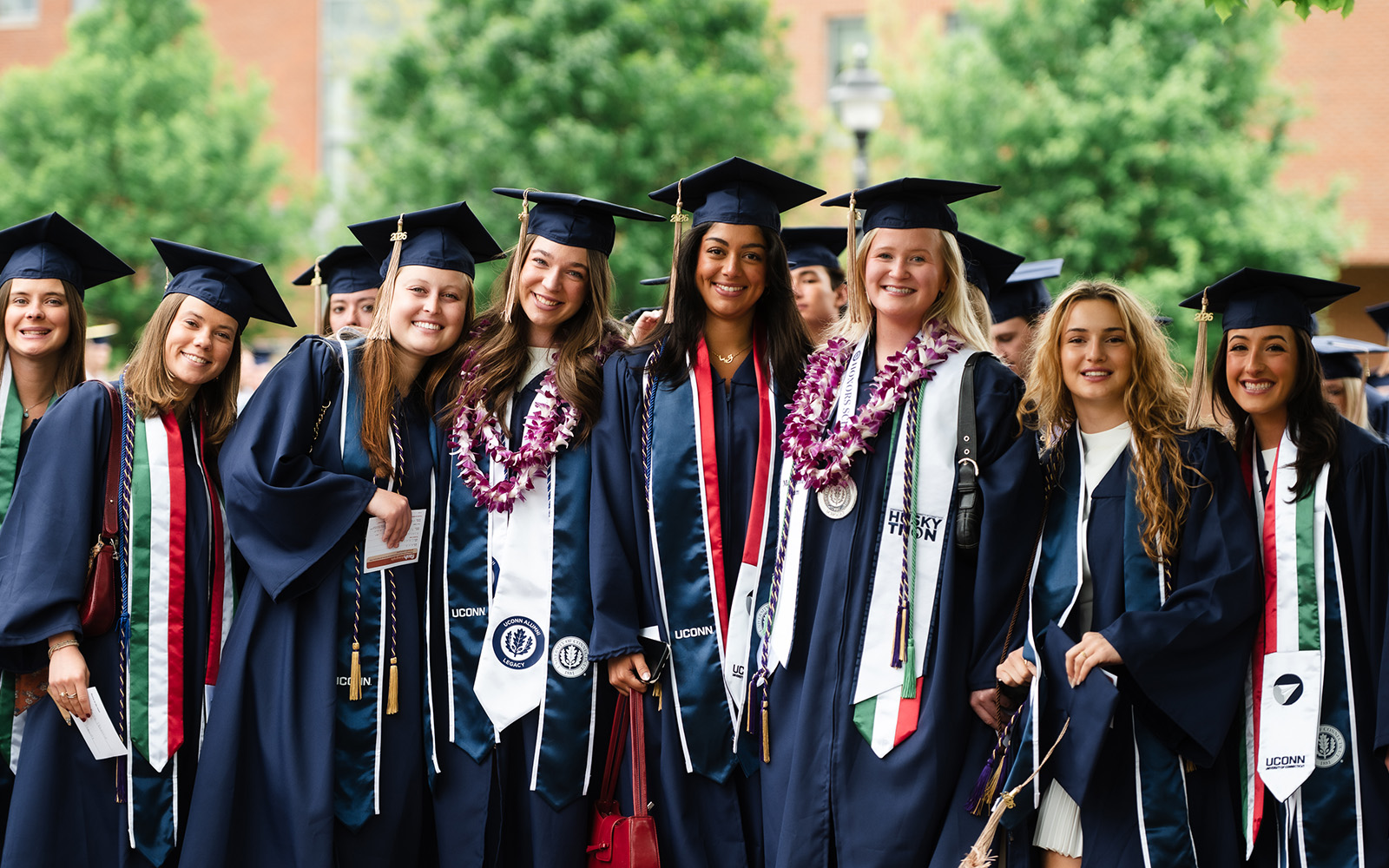 A group of friends pose for a photo before their graduation from the School of Business on Saturday. (Nathan Oldham / UConn School of Business)